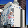 Frank Stella's mural "Dusk (Moby Dick Series)" wraps the facade of the Olive St. building.