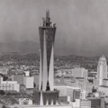 Microwave tower against the downtown skyline with city hall to the right.