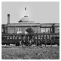 Electric train in front of high school