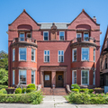 Romanesque Revival house (c. 1880; 103–105 Washington) designed by Bruce Price.