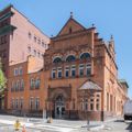 The Romanesque Revival Second National Bank (1880s; 71 Baltimore) is a tour-de-force of carved brownstone detail and orange brick.