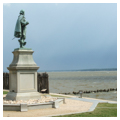 John Smith statue with reproduction palisade and seawall extending into James River
