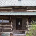 Detail, exterior closet near stone chimney