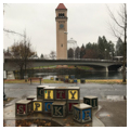 Park view with Great Northern Clock Tower beyond Spokane River